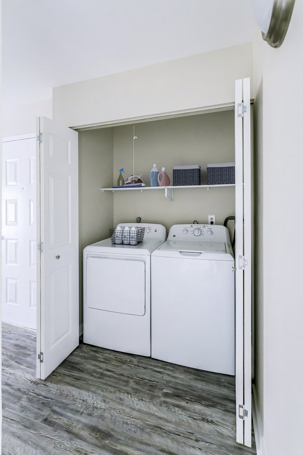 Laundry room featuring modern appliances at Sun River Village Apartments