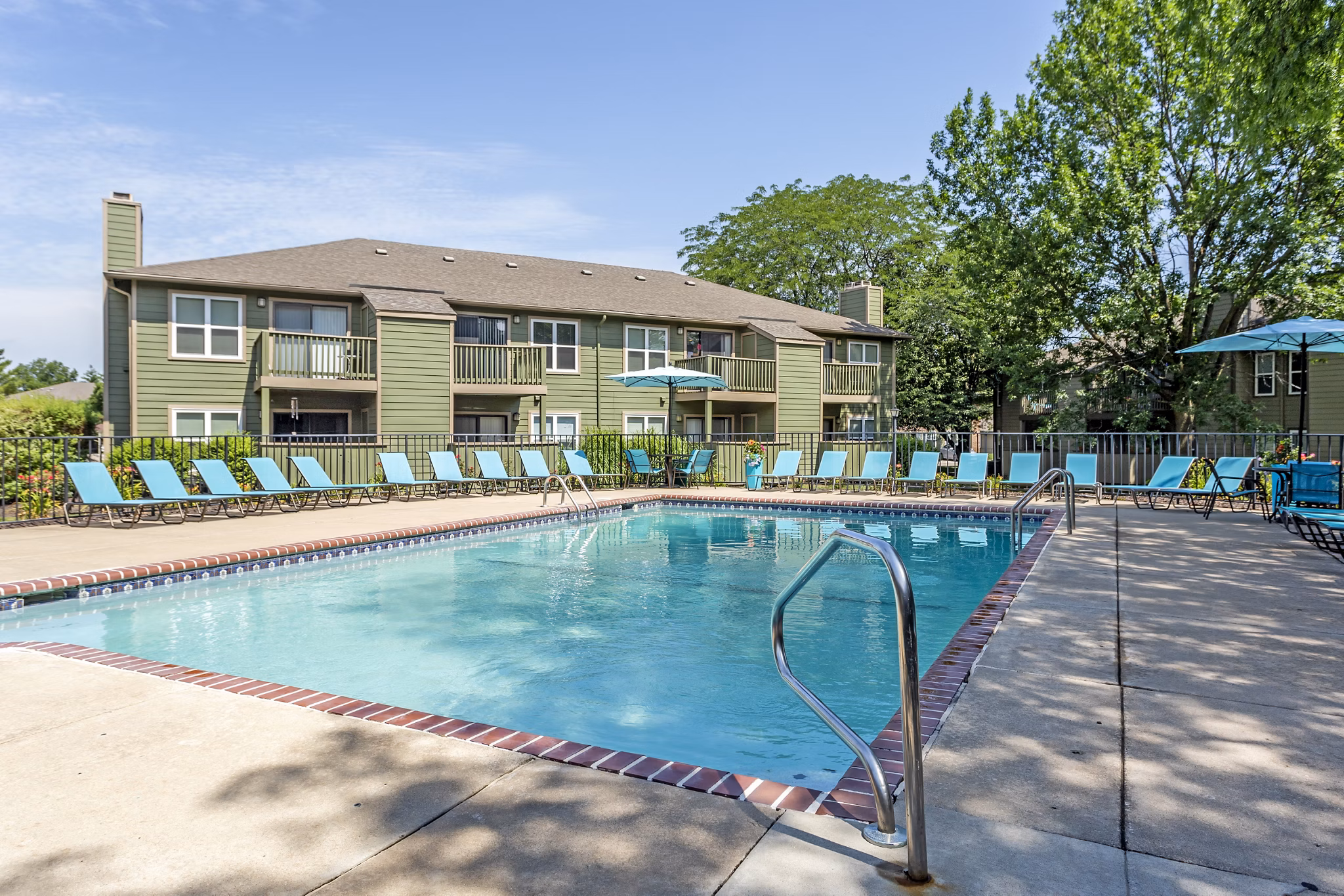 Relaxing outdoor pool area at Sun River Village Apartments, perfect for leisure and socializing under the sun