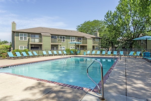 Relaxing outdoor pool area at Sun River Village Apartments, perfect for leisure and socializing under the sun