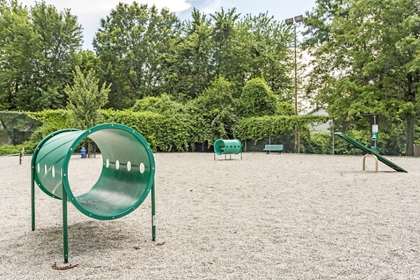 Dog park with agility course features at Sun River Village Apartments
