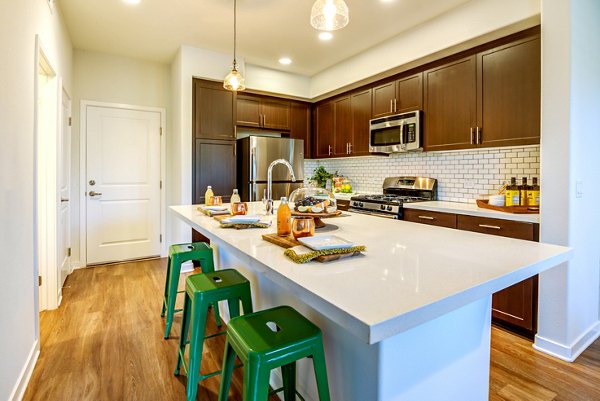 Stylish kitchen with modern appliances at Encanto Apartments, a luxury Greystar property