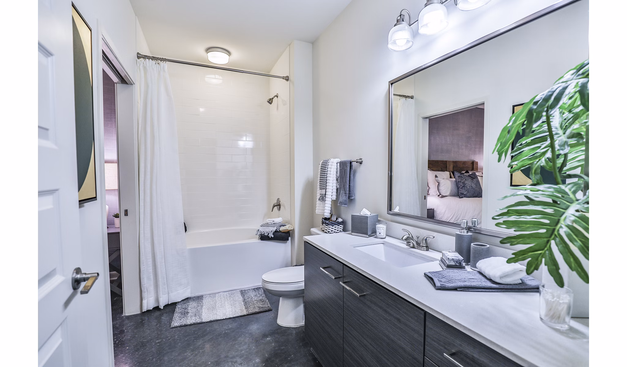 Bathroom with modern fixtures and tiled shower at Ayla Apartments luxury residences