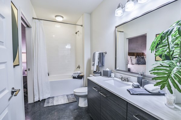 Bathroom with modern fixtures and tiled shower at Ayla Apartments luxury residences