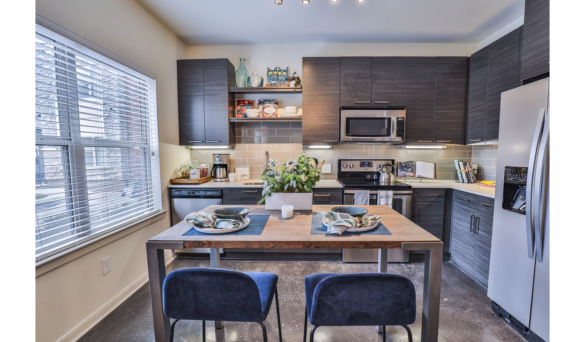 Modern kitchen with stainless steel appliances at Ayla Apartments