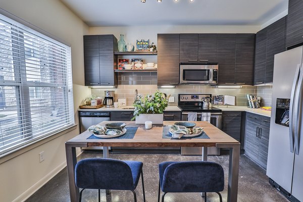 Modern kitchen with stainless steel appliances at Ayla Apartments