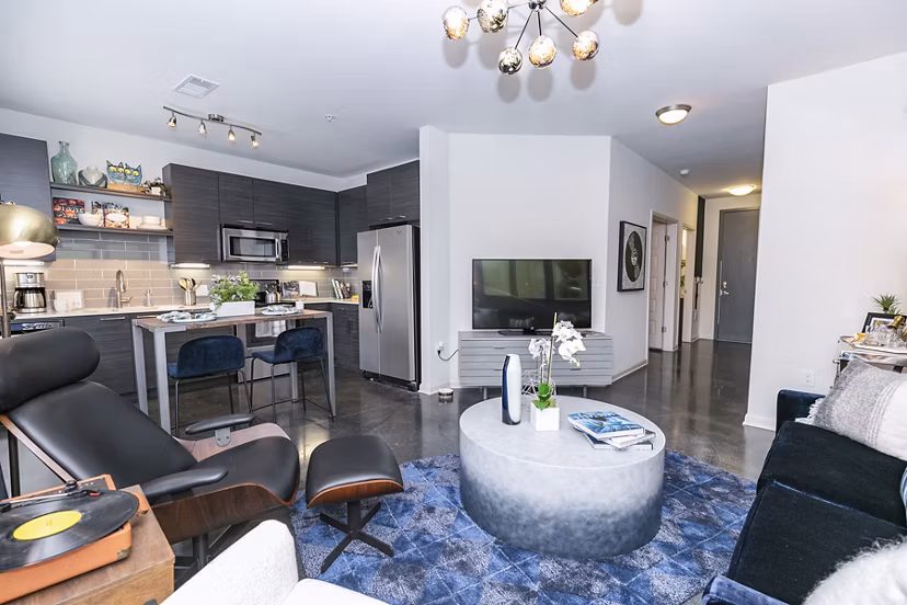Spacious living room with modern decor in Ayla Apartments, featuring stylish furniture and large windows