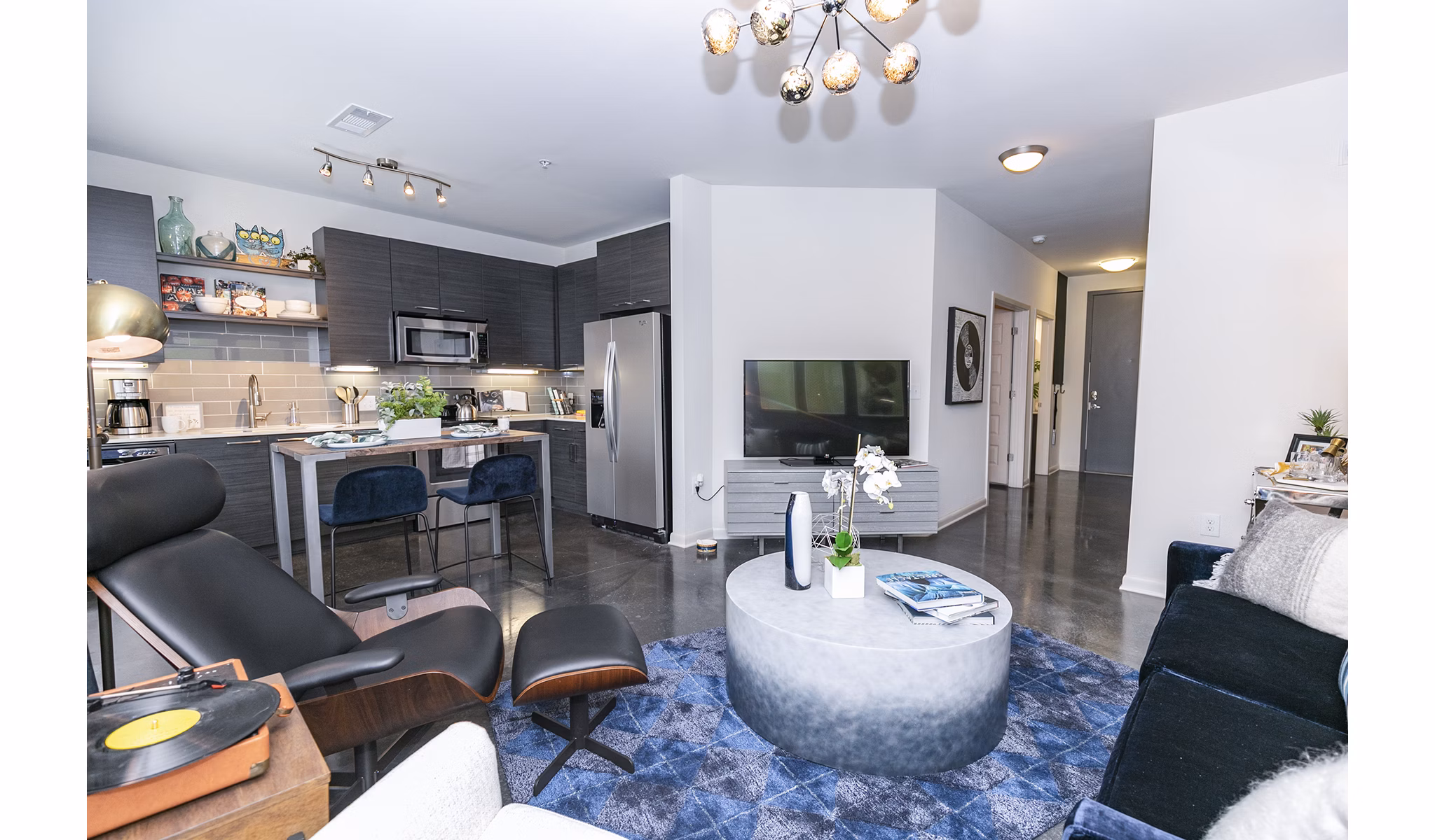 Spacious living room with modern decor in Ayla Apartments, featuring stylish furniture and large windows
