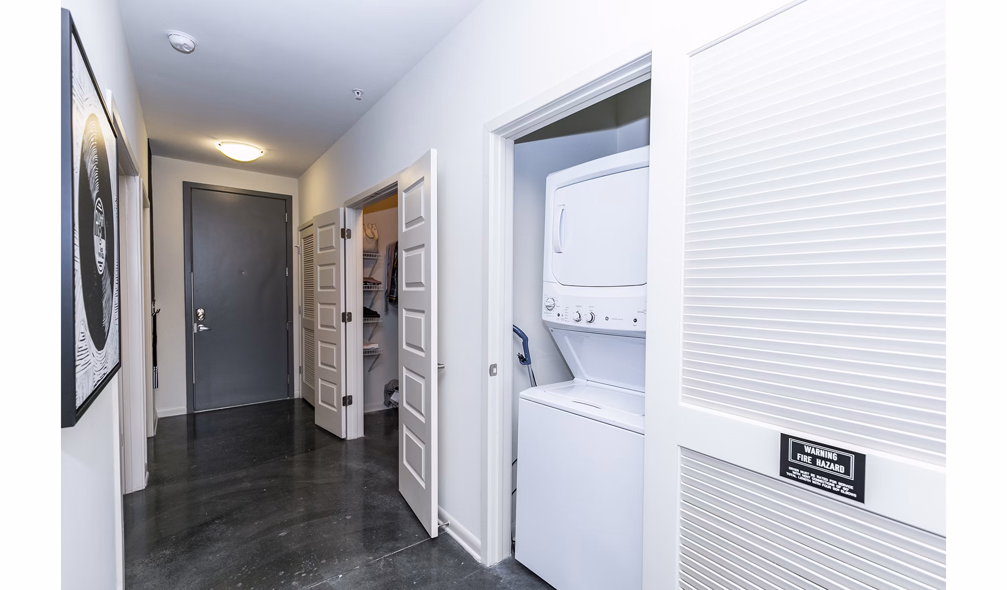 Laundry room featuring modern washers and dryers at Ayla Apartments