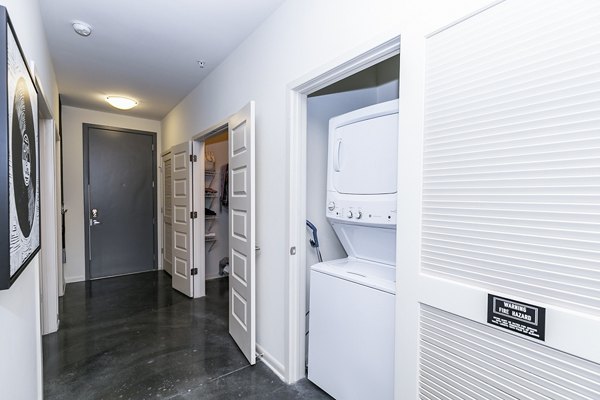 Laundry room featuring modern washers and dryers at Ayla Apartments