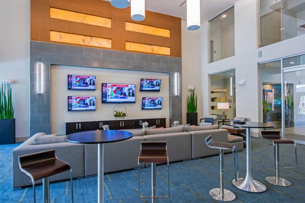 Clubhouse featuring modern design and cozy seating at Domain West Apartments, ideal for social gatherings and relaxation