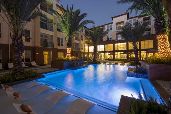 Luxurious pool area with lounge chairs at Domain West Apartments