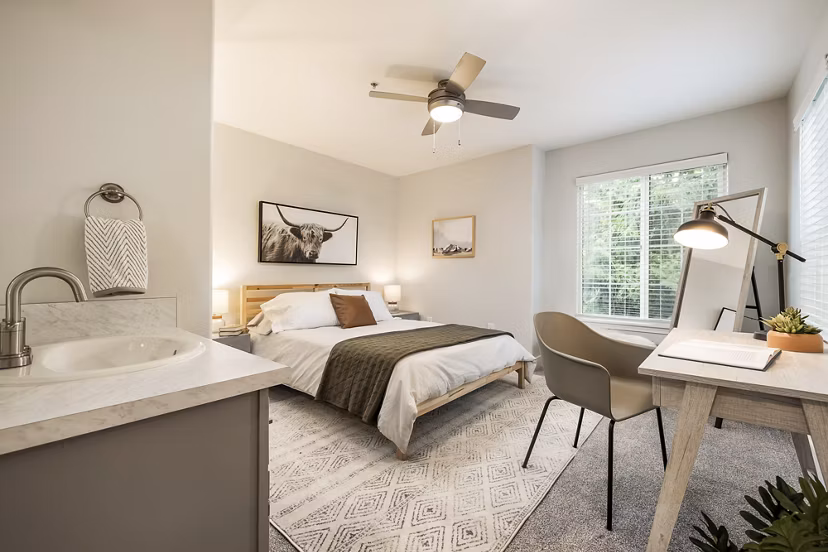 Cozy bedroom with modern furnishings at Canyon Creek Apartments featuring luxury amenities
