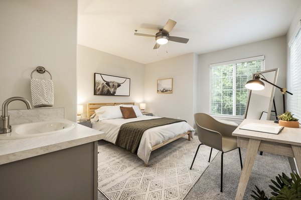 Cozy bedroom with modern furnishings at Canyon Creek Apartments featuring luxury amenities
