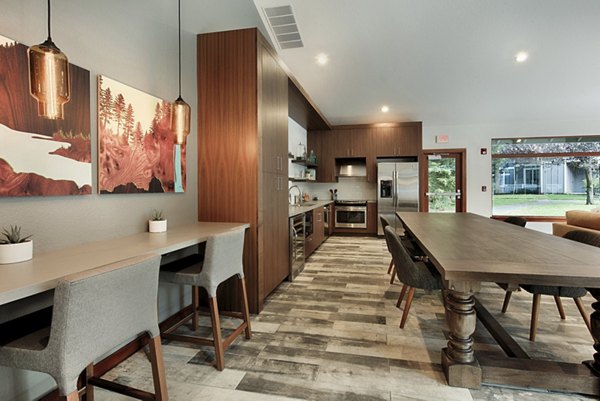 Clubhouse with modern seating and large windows at Canyon Creek Apartments, luxury living by Greystar