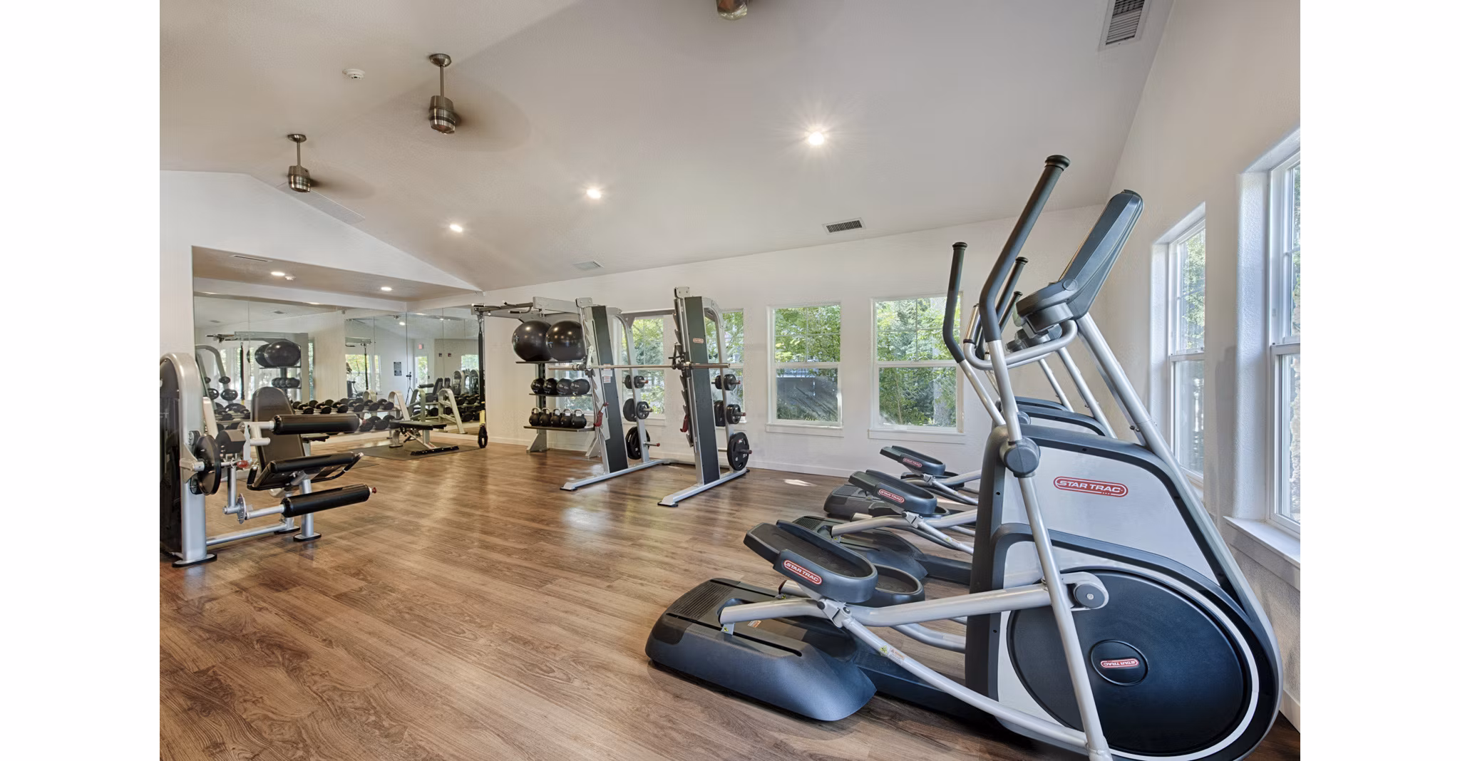 Canyon Creek Apartments: Fully-equipped fitness center with modern gym machines and free weights for residents