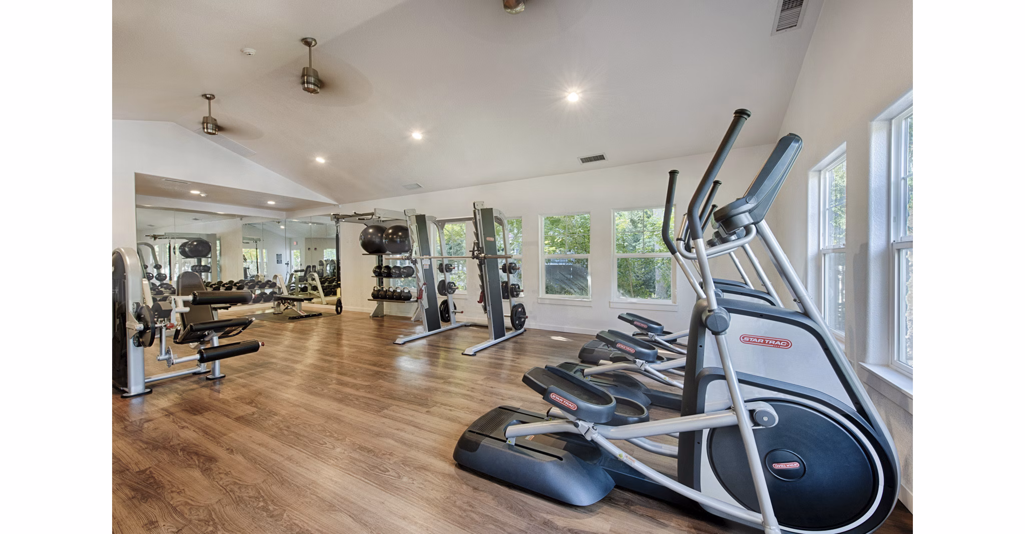 Canyon Creek Apartments: Fully-equipped fitness center with modern gym machines and free weights for residents