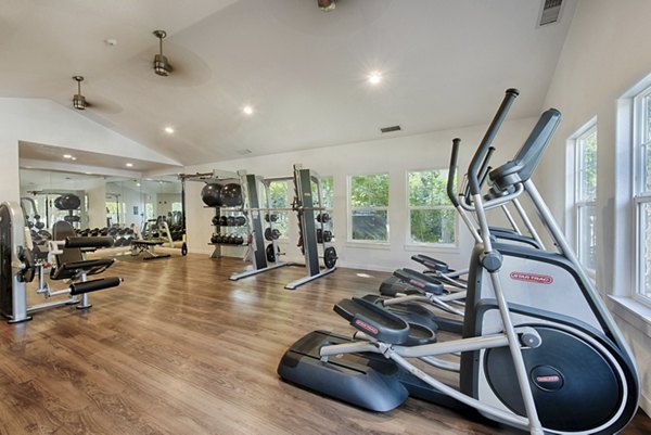 Canyon Creek Apartments: Fully-equipped fitness center with modern gym machines and free weights for residents