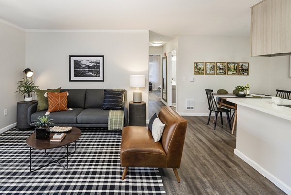 Modern living room with stylish furniture and dining area in luxury apartments