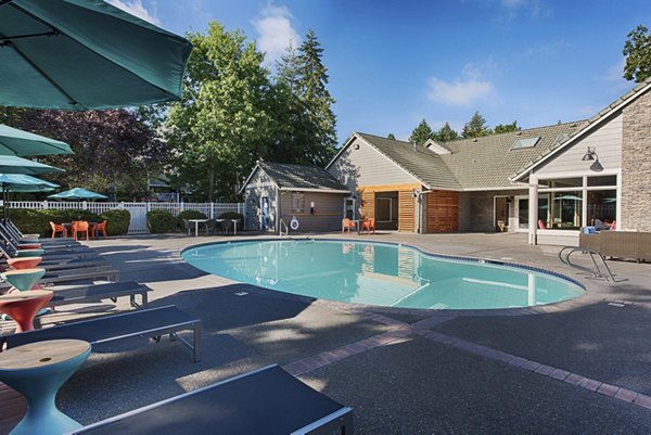 Outdoor pool with sun loungers at Canyon Creek Apartments