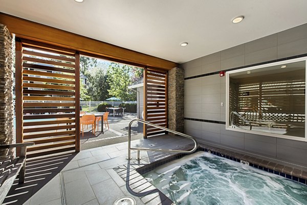 Outdoor pool surrounded by lush landscaping at Canyon Creek Apartments