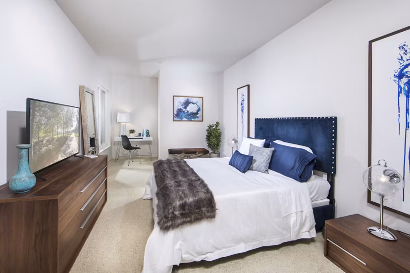 Modern bedroom with chic decor and large window at The Mix at CTR CITY luxury apartments