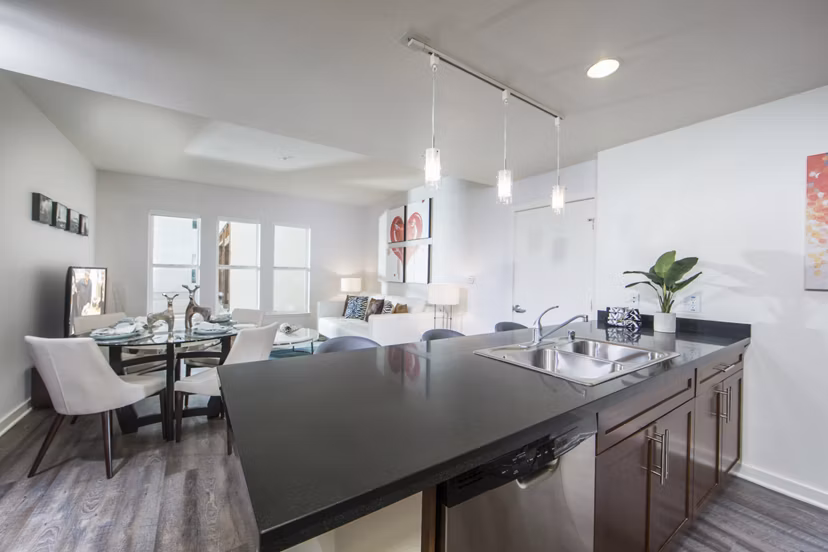 Modern kitchen with sleek cabinetry and marble countertops in The Mix at CTR CITY apartments