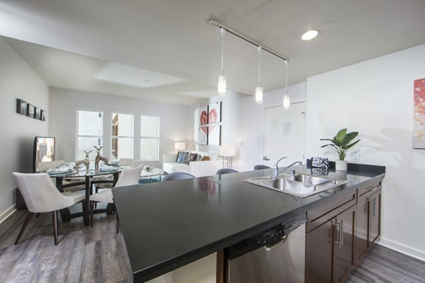 Modern kitchen with sleek cabinetry and marble countertops in The Mix at CTR CITY apartments