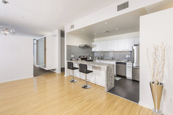 Modern kitchen with sleek countertops and stainless steel appliances at The Mix at CTR CITY apartments Perfect for luxury urban living