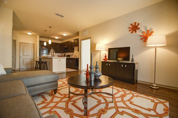 Modern living room with sleek furniture and ample natural light at Capital Place at Southwood Apartments