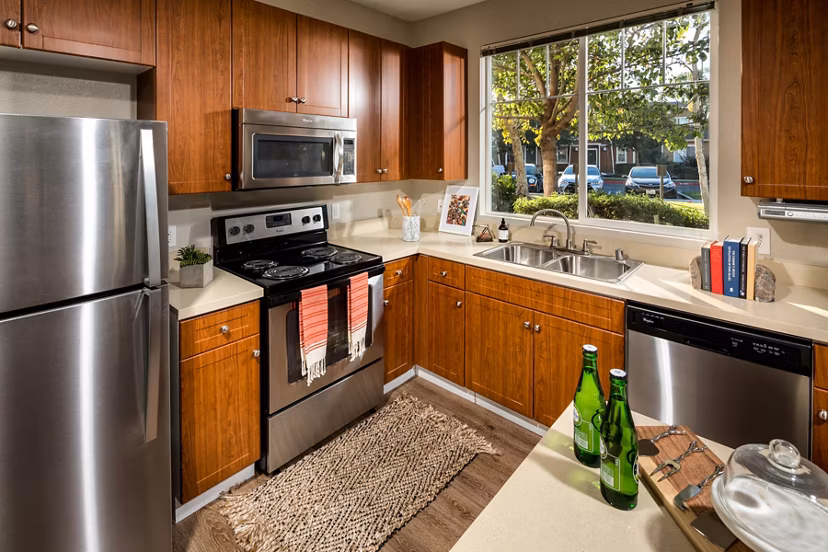 Modern kitchen featuring stainless steel appliances and granite countertops at Montiavo Apartments