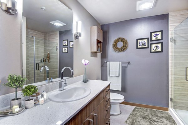 Modern bathroom with sleek fixtures at Cue Apartments