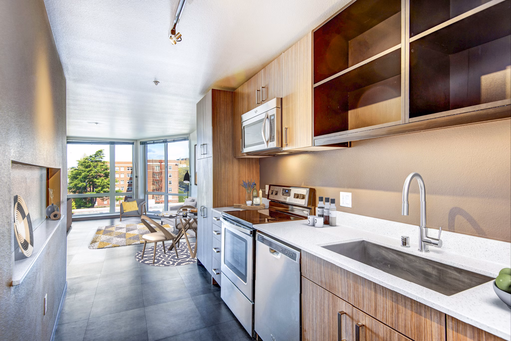 Modern kitchen with stainless steel appliances at Cue Apartment Homes, offering luxury living in a prime location