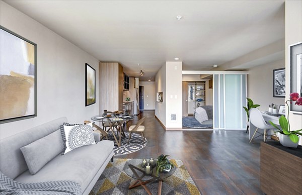 Spacious living room with modern furnishings in Cue Apartments
