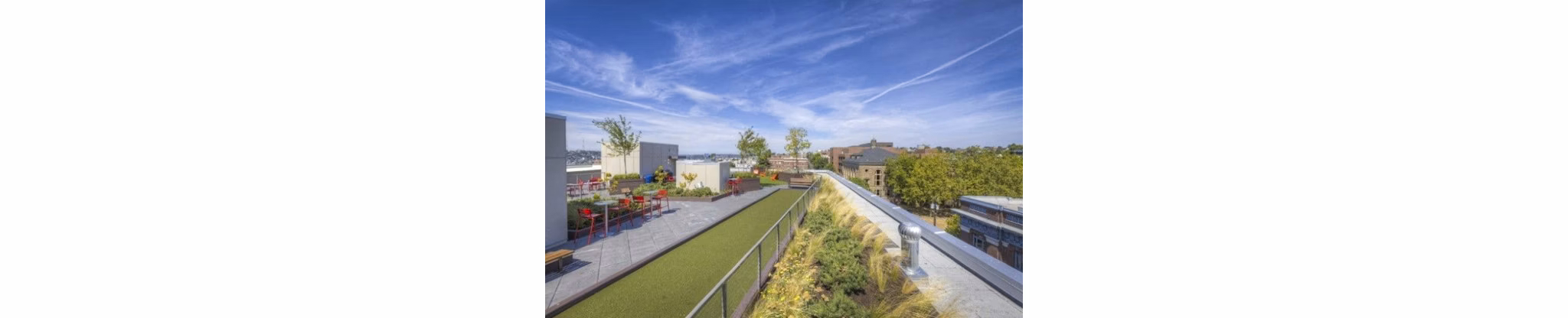 Balcony with cozy seating area at Cue Apartments, offering urban luxury living with city views