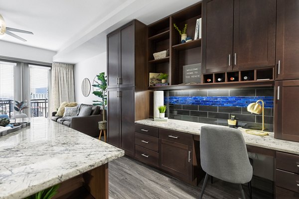 Luxurious open-concept kitchen with modern stainless steel appliances in The Kenzie at The Domain Apartments