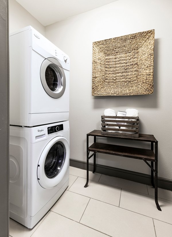 Laundry room with modern appliances at The Kenzie in The Domain Apartments