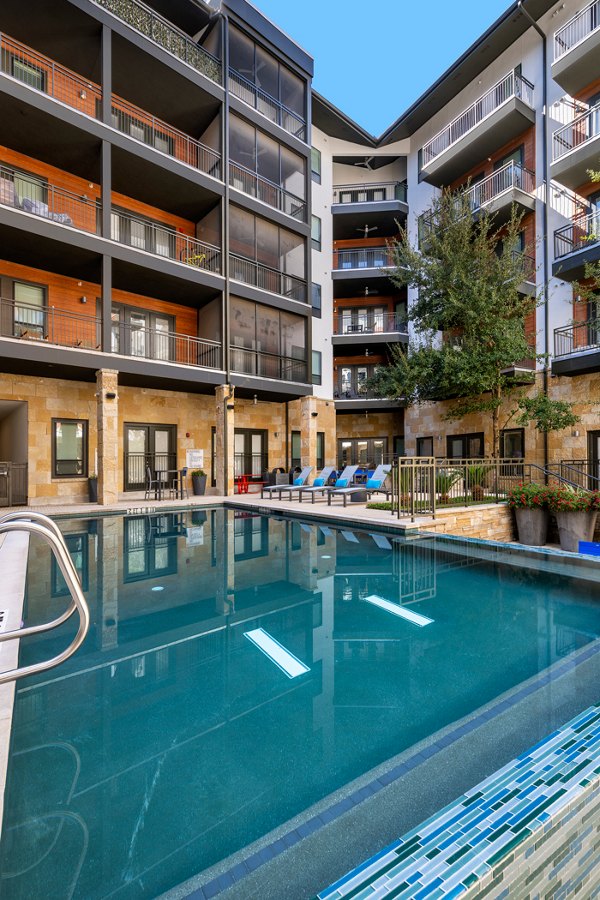 Resort-style pool with sun deck at The Kenzie at The Domain apartments