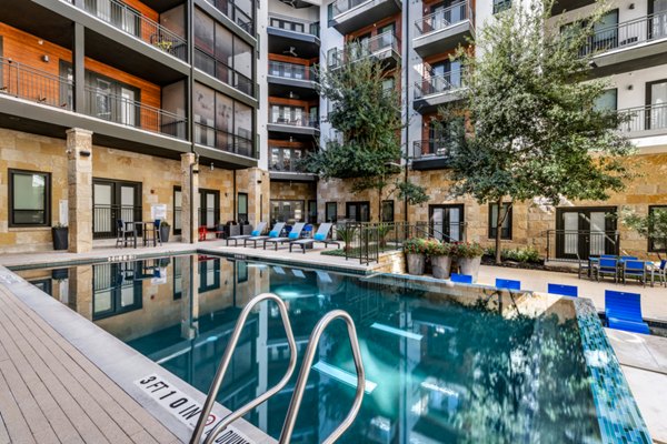 Rooftop pool with sun loungers at The Kenzie at The Domain Apartments offering luxury amenities