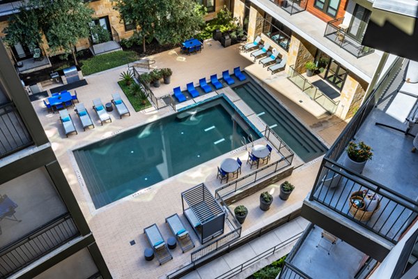 Poolside relaxation area at The Kenzie at The Domain Apartments with luxury amenities