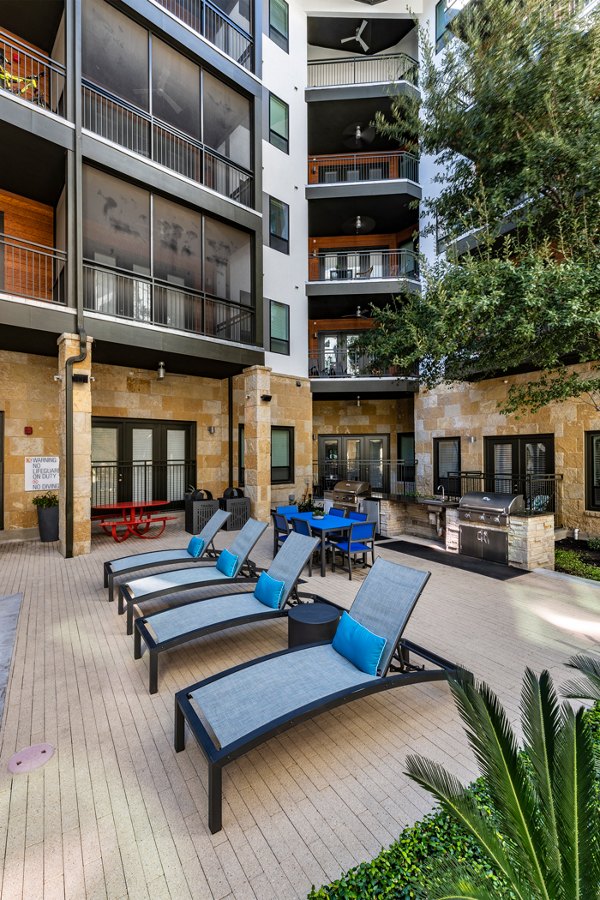 Tranquil courtyard with lush landscaping at The Kenzie at The Domain Apartments