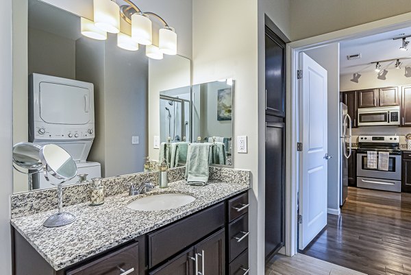 Bright bathroom with dual sinks and modern fixtures in Album Quail Springs Apartments