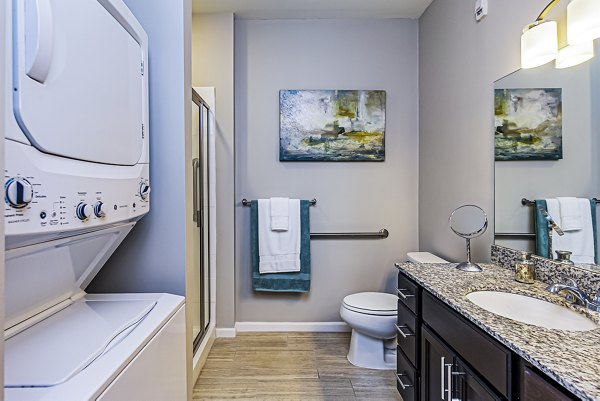 Modern bathroom with sleek fixtures and laundry amenities at Album Quail Springs Apartments