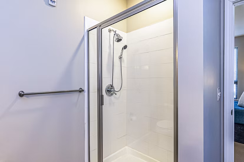 Walk-in shower with modern fixtures in the bathroom at Album Quail Springs Apartments