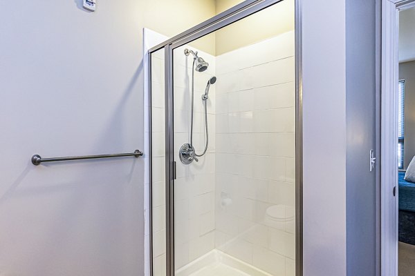 Walk-in shower with modern fixtures in the bathroom at Album Quail Springs Apartments
