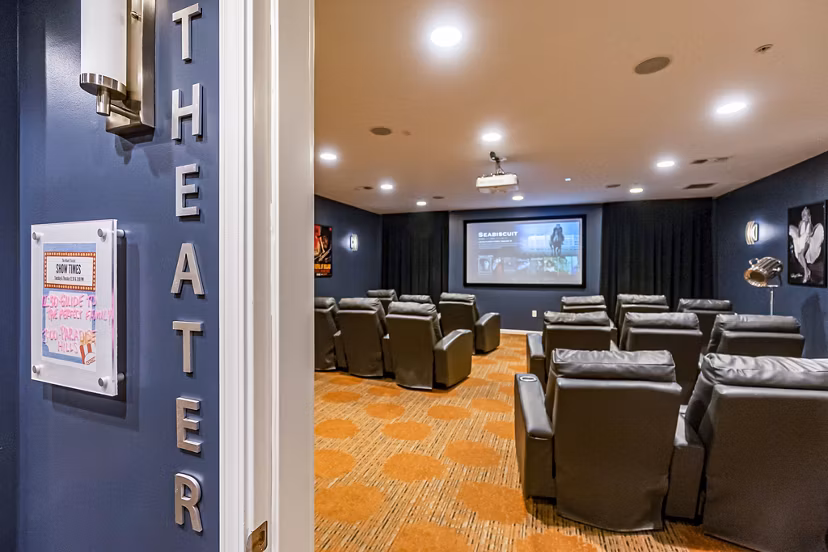 Theater with tiered seating and surround sound at Album Quail Springs Apartments, offering a luxury apartment living experience