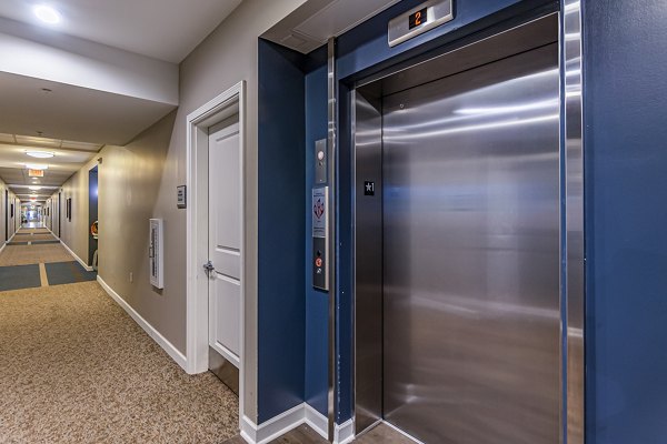 Hallway with modern elevator at Album Quail Springs Apartments, luxury living by Greystar