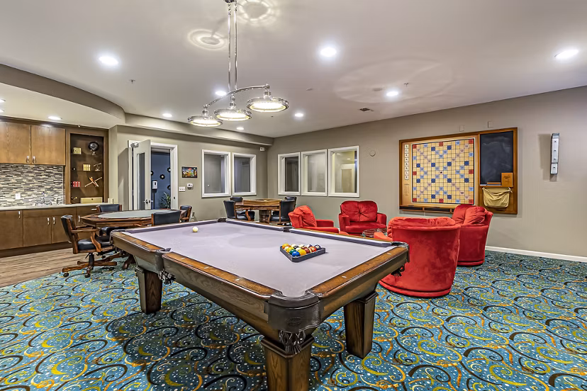 Modern game room with billiards and seating at Album Quail Springs Apartments, offering luxury lifestyle amenities for residents