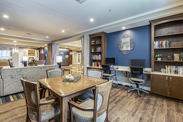 Business center with modern workstations at Album Quail Springs Apartments, ideal for remote work or study