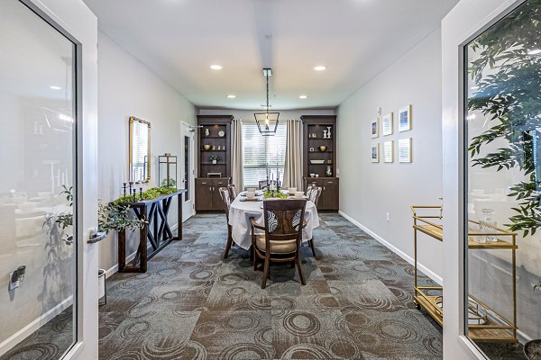 Community dining room with modern furnishings at Album Quail Springs Apartments, perfect for social gatherings and resident events