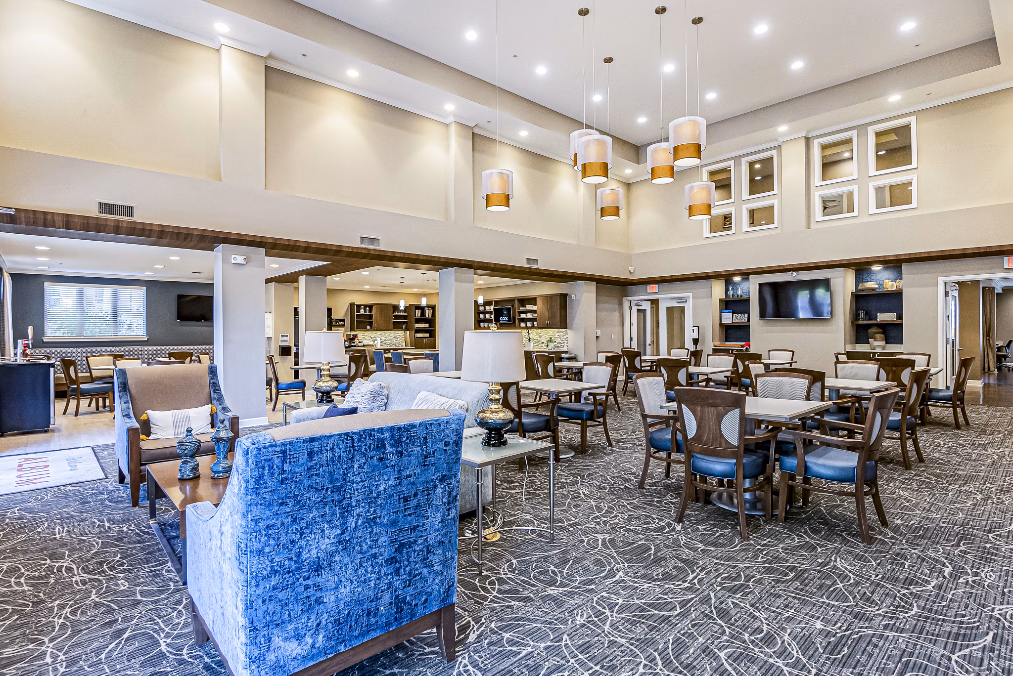 Clubhouse with modern design at Album Quail Springs Apartments, featuring lounge seating and social areas in a luxury setting